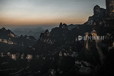 Helicopter point of view of  mountain roads curving through Tianmen mountain (天门山) in the pooling fog, Hunan Province (湖南省), China